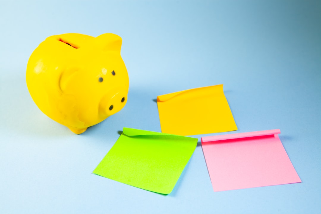 Piggy bank and sticky notes isolated on blue background with copy space