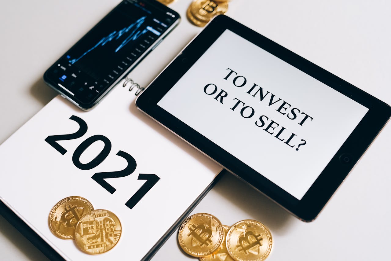 Bitcoin and investment strategy visualized with smartphone, tablet, and coins.